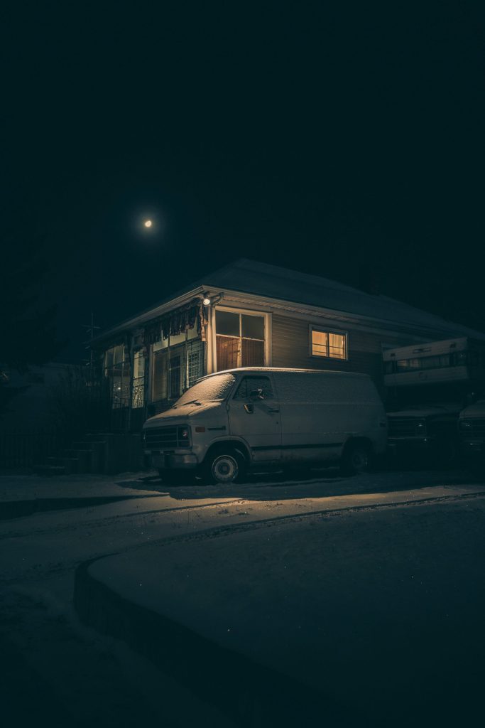 white panel van parked beside house